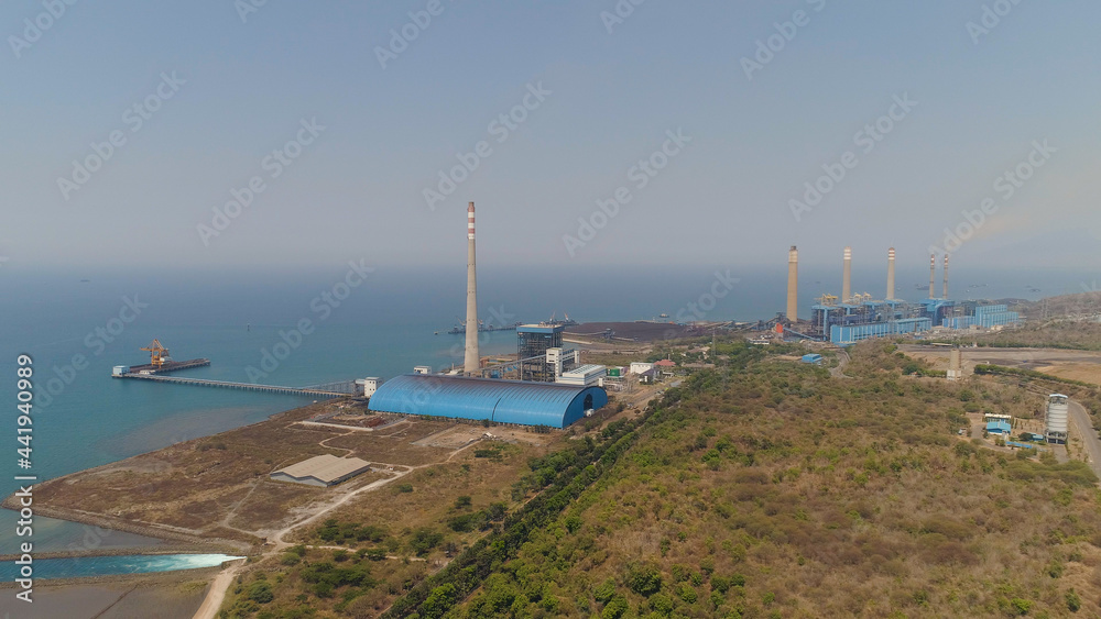 power station by sea with smoking pipes, paiton java, indonesia. aerial view power plant in asia.