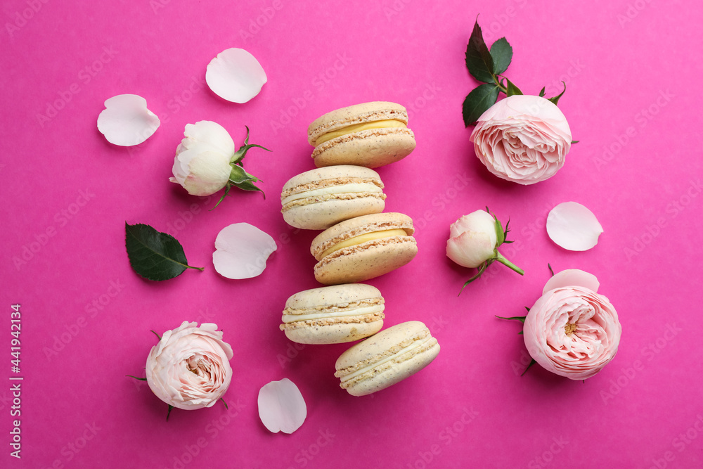 Flat lay composition with macarons and roses on pink background Flat lay composition with macarons and roses on pink background