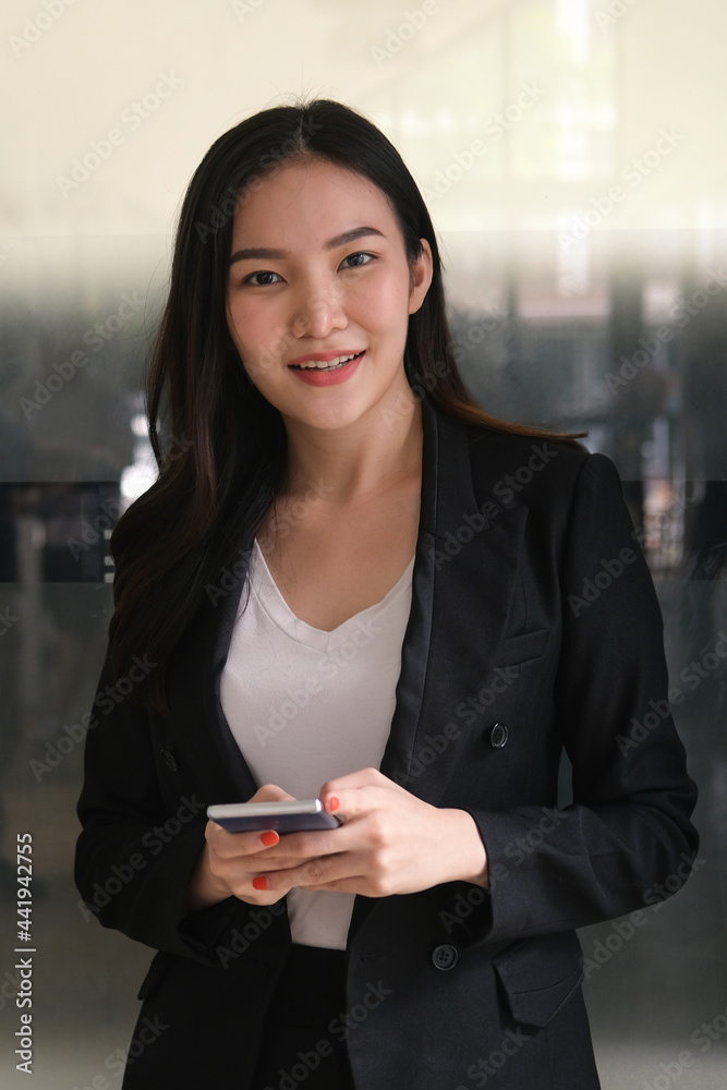 Portrait with lady boss wear office suit outfit hold smartphone and looking smart, Working women concept, Business and. finance concept.