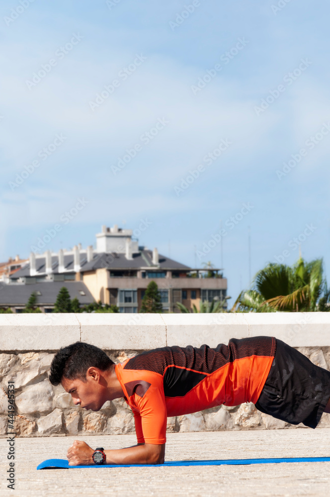 Athlete stretching with city background