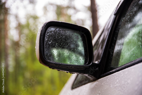 car rearview mirror in drops of water