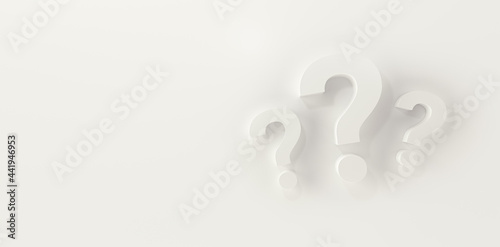 Three question marks in panoramic white studio background. photo