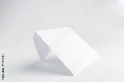 White mail envelope with a place for the inscription stands at an angle on a white background 