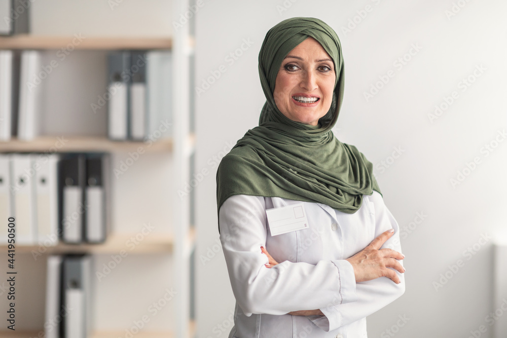 Mature Muslim Doctor Woman Wearing Hijab Posing In Clinic Office