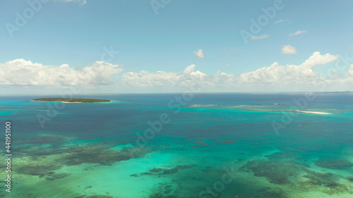 Seascape: Blue sky with clouds over the sea with islands, aerial view. Summer and travel vacation concept. Siargao,Philippines.