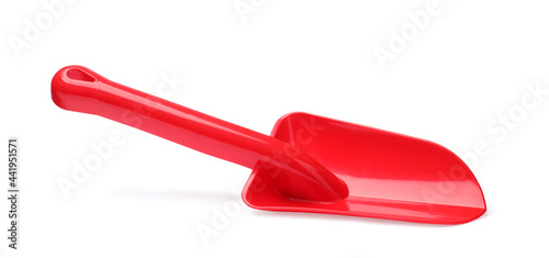Red plastic toy shovel isolated on white
