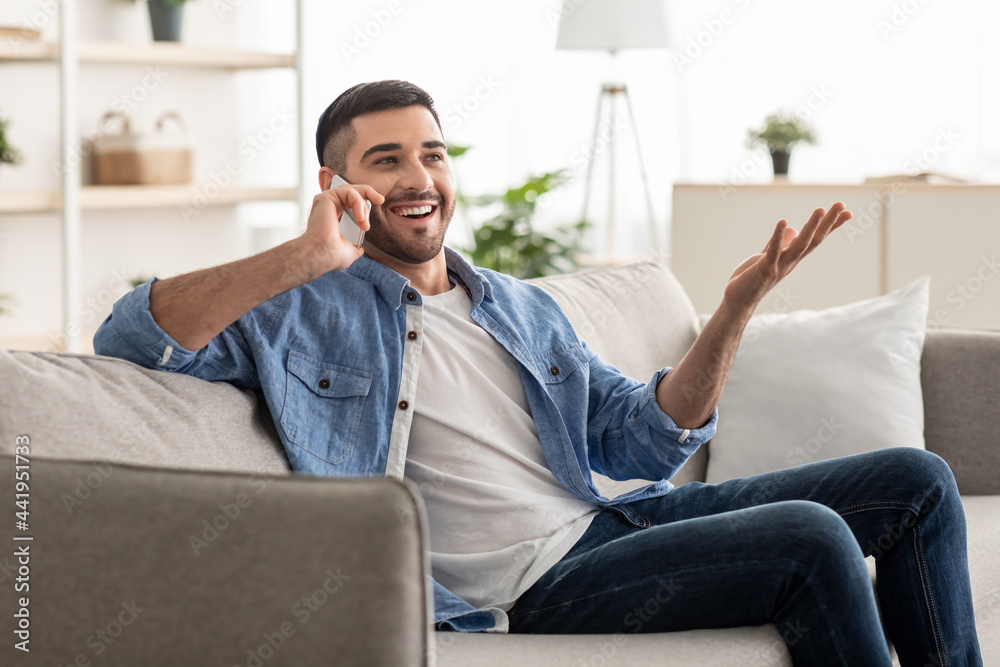 Portrait of smiling israeli man talking on phone at home Portrait of smiling israeli man talking on phone at home