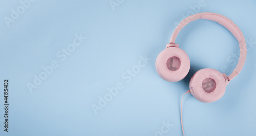 pink headphones on blue background