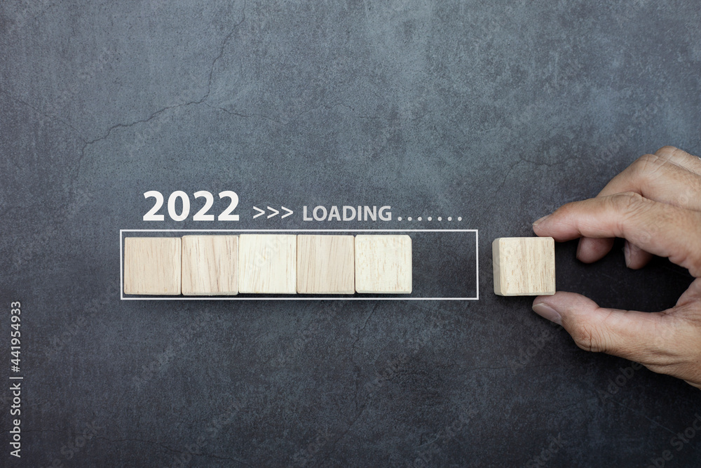 Loading new year 2022 concept, hand man putting cube wooden on process ...