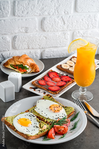 A set of products for a delicious European Breakfast Scrambled eggs, croissants and orange juice