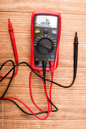 Electronic digital multimeter isolated on white with probes. Digital multimeter with red and black leads. Electronic multimeter isolated on white background close up