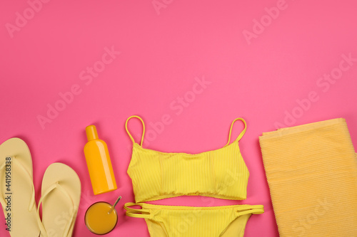 Flat lay composition with beach objects on pink background, space for text