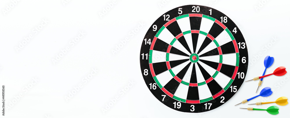 Dartboard and darts on white background with copy space.