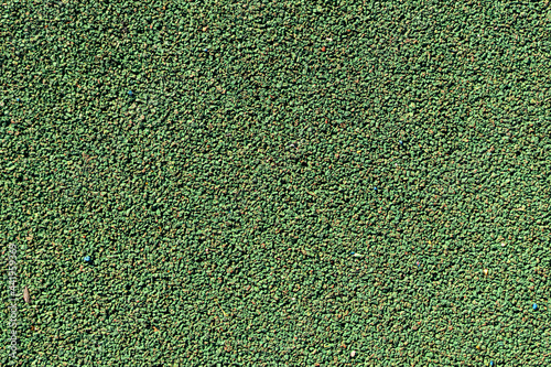 Abstract textured sport field background. Top view of green rubber turf surface of playground. Copy space for your text and decorations. Artificial soccer (football) field.
