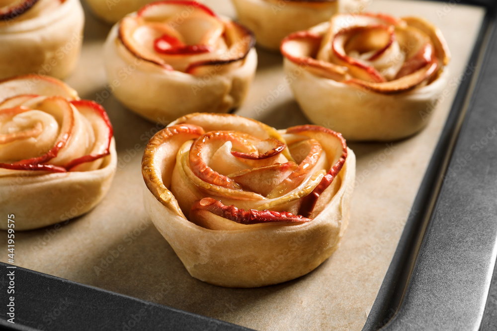 Tray with freshly baked apple roses, closeup view. Beautiful dessert Tray with freshly baked apple roses, closeup view. Beautiful dessert
