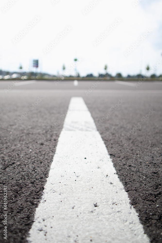 White line on dark asphalt close-up. Parking lines White line on dark asphalt close-up. Parking lines