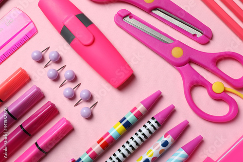 Flat lay composition with stationery on pink background