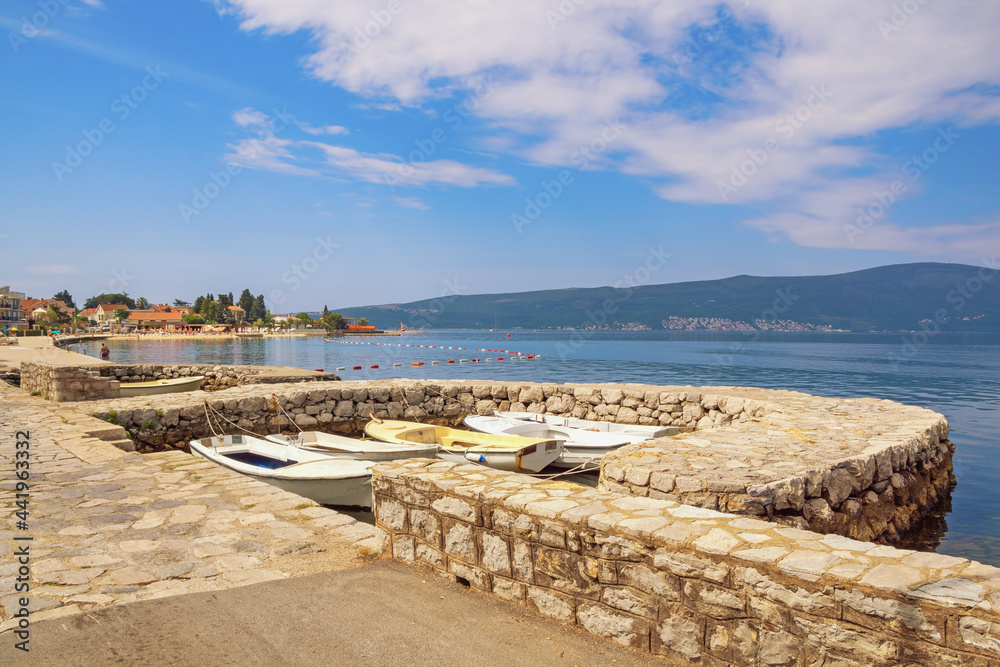 Fototapeta premium Beautiful summer Mediterranean landscape. Montenegro, Adriatic Sea. Coast of Bay of Kotor near Tivat city. Mandrac ( mandrach ) is stone jetty for fishing boats, cultural heritage in Kotor Bay.