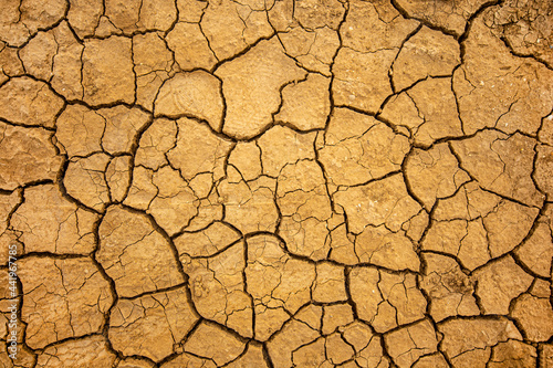 Drought and soil dehydration background. Dry cracked earth texture.