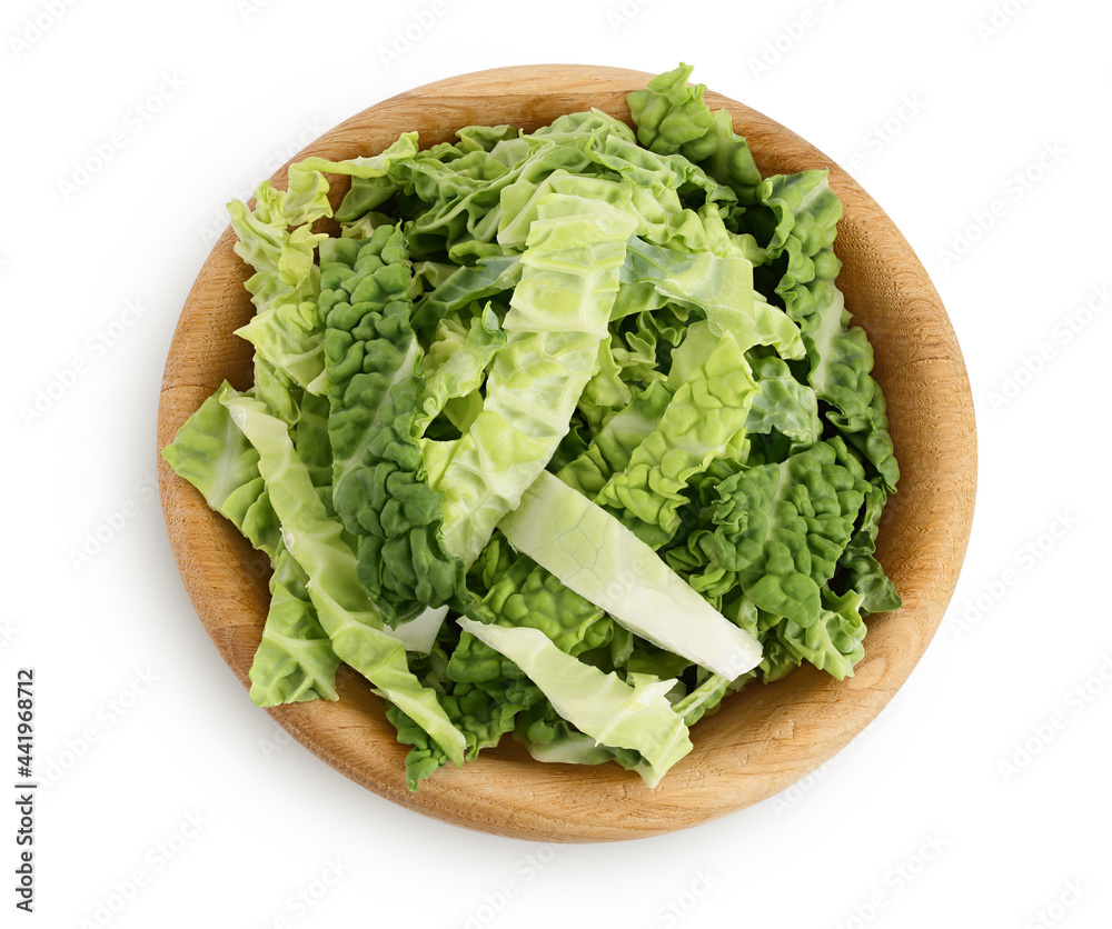 chopped savoy cabbage in wooden bowl isolated on white background with clipping path and full depth of field. Top view. Flat lay chopped savoy cabbage in wooden bowl isolated on white background with clipping path and full depth of field. Top view. Flat lay