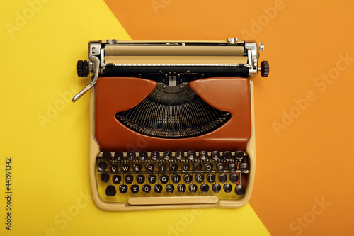 Vintage typewriter on color background, top view