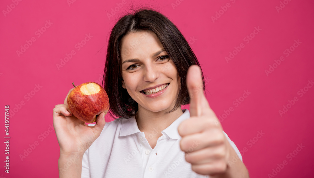 Beautiful young woman hold a big apple in her hand Beautiful young woman hold a big apple in her hand