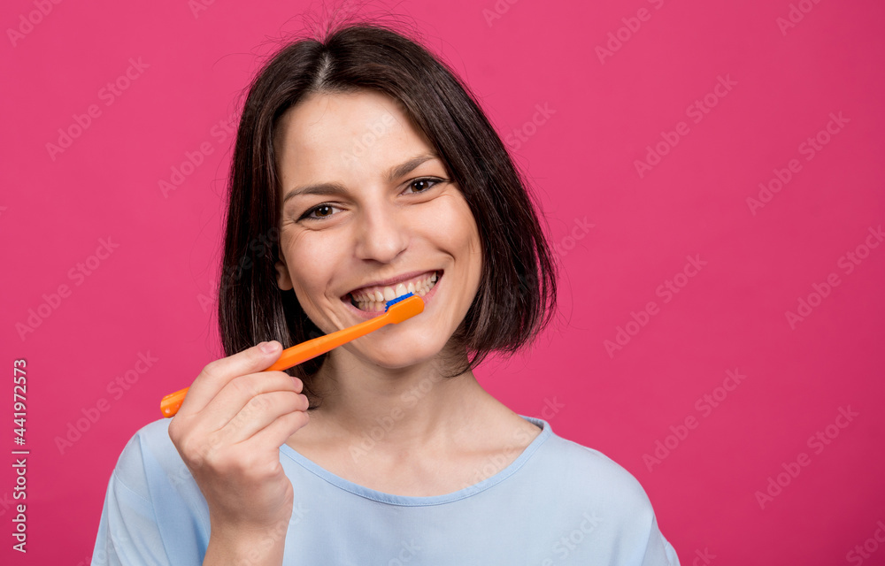 Beautiful happy young woman with toothbrush on blank pink background Beautiful happy young woman with toothbrush on blank pink background