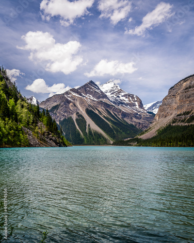 The turquoise water of Kinney Lake in Robson Provincial Park in the Canadian Rockies in British Columbia, Canada. Whitehorn Mountain and Cinnamon Peak in the background