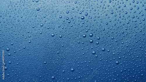 water drops on metallic blue background