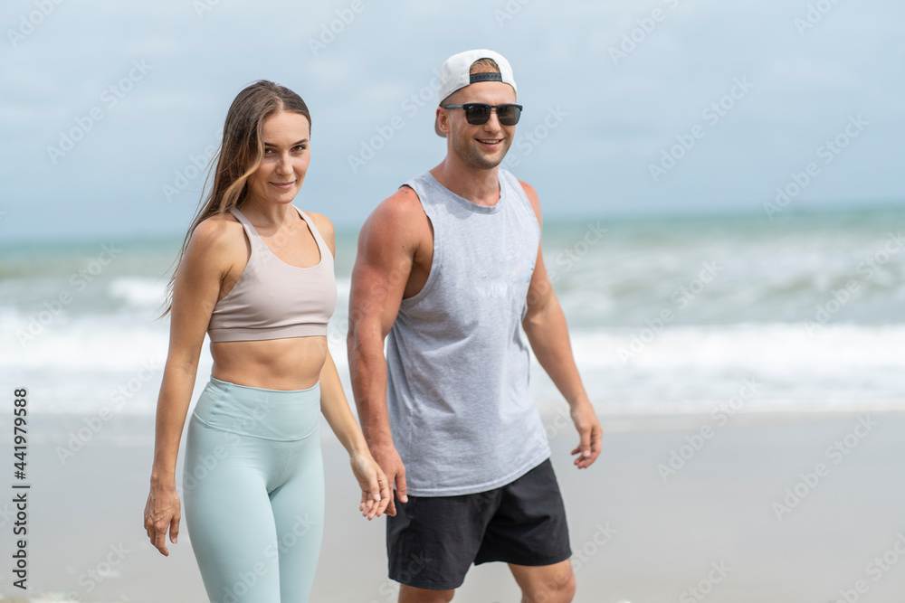 Beautiful girl and her friend walking exercise on the beach by the sea. Beautiful girl and her friend walking exercise on the beach by the sea.