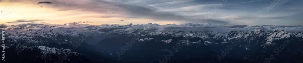 Aerial Panoramic View from Airplane of Canadian Mountain Landscape in Spring time. Colorful Sunset. North of Vancouver, British Columbia, Canada. Nature Panorama, Dark Moody Art Render