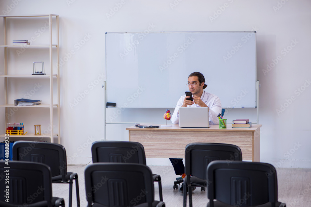 Young male doctor giving seminar in the classroom Young male doctor giving seminar in the classroom