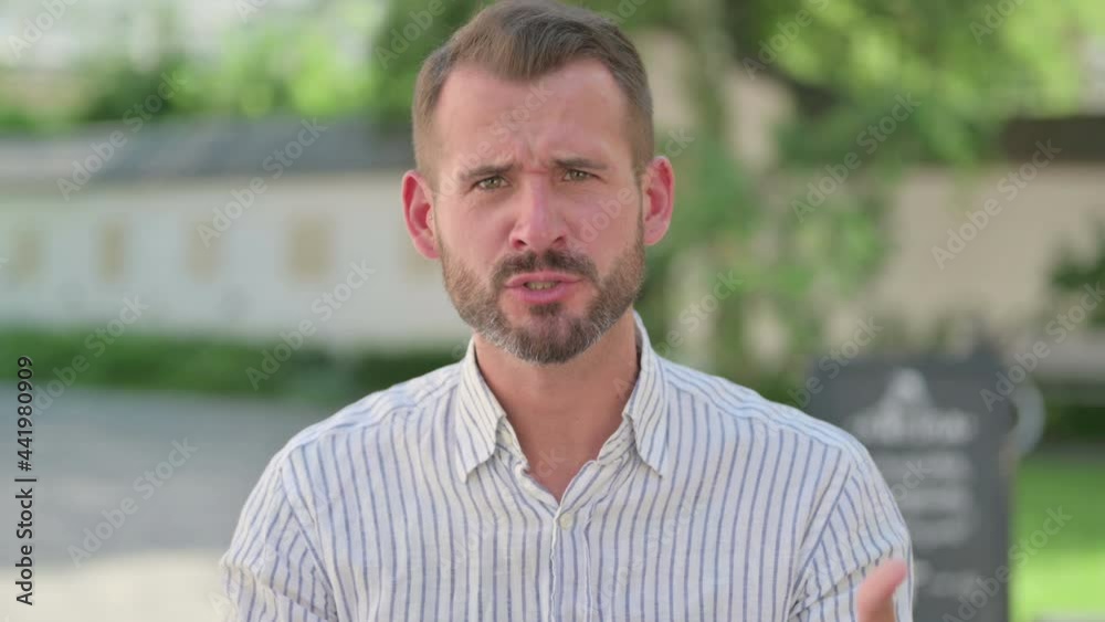 Outdoor Portrait of Angry Middle Aged Man Arguing, Fighting Outdoor Portrait of Angry Middle Aged Man Arguing, Fighting