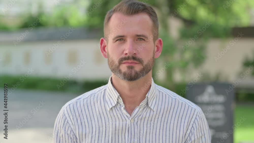 Outdoor Portrait of Middle Aged Man Looking at Camera Outdoor Portrait of Middle Aged Man Looking at Camera