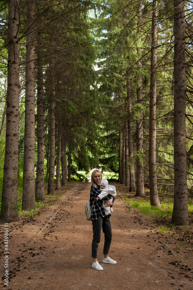 Beautiful mother with a child in the autumn forest, a mother with her son on a walk, a woman blonde with long hair Beautiful mother with a child in the autumn forest, a mother with her son on a walk, a woman blonde with long hair