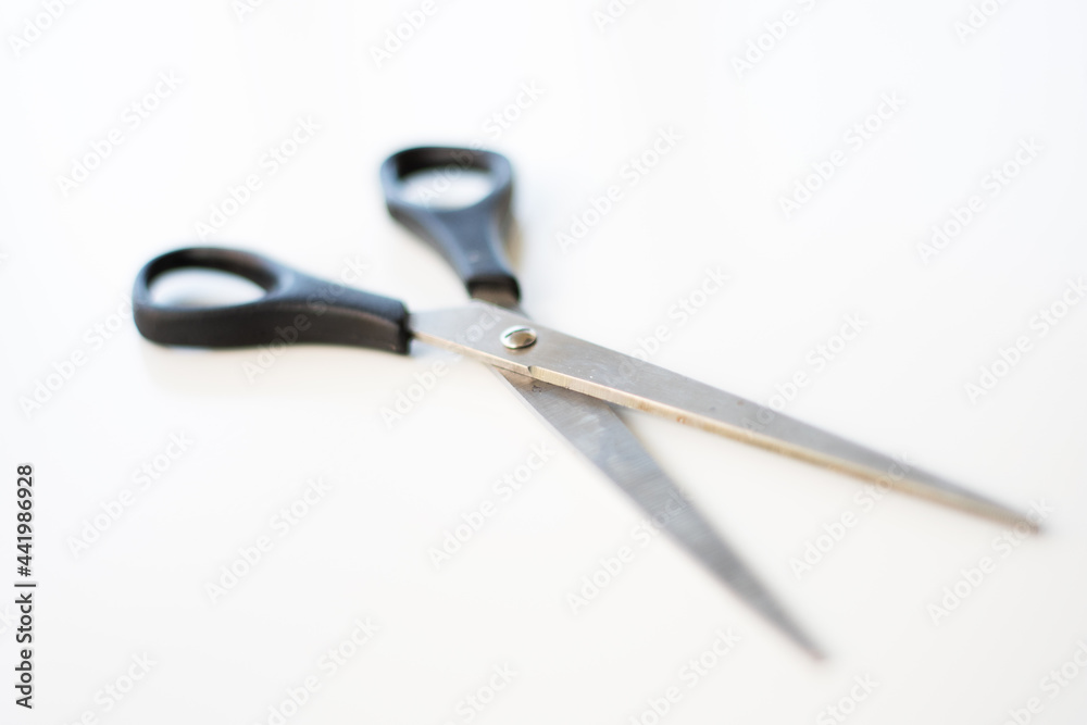 Scissors on white background. Selective focus. Blurred areas. Copy space. Scissors on white background. Selective focus. Blurred areas. Copy space.
