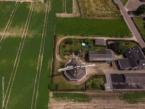 Top down aerial view of Dutch windmill in agriculture countryside landscape in The Netherlands photo