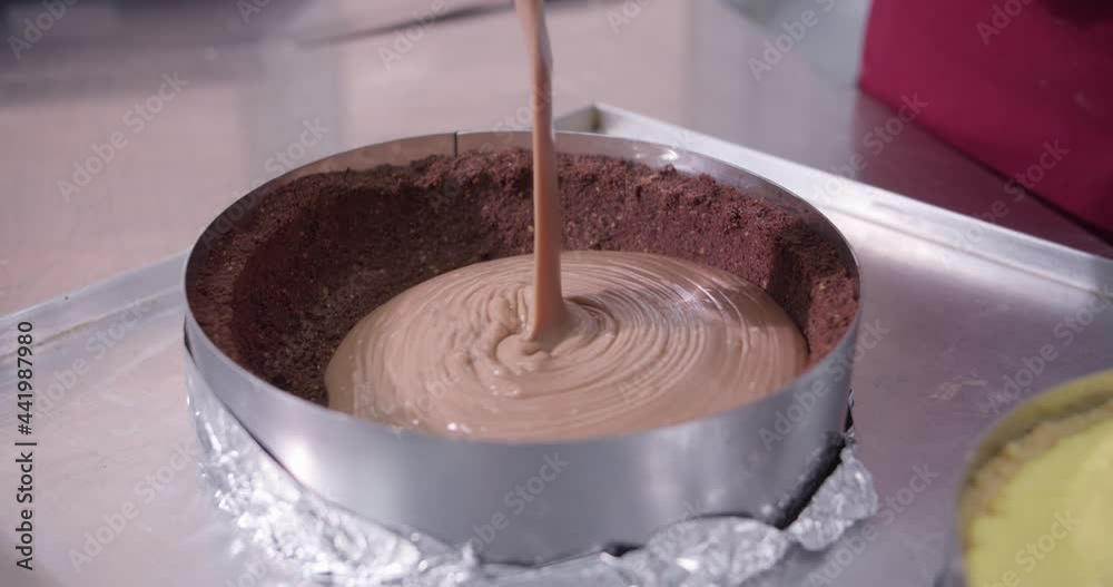 Professional pastry chef Pouring melted chocolate on cake. Confectionery, and desserts . Professional pastry chef Pouring melted chocolate on cake. Confectionery, and desserts .