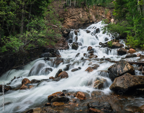 Waterfall cascading down from mountain during peak run off in Colorado, USA
