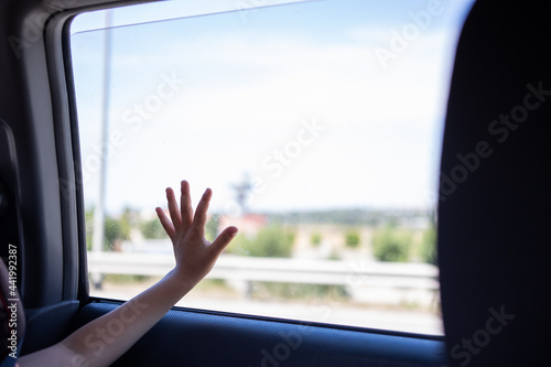 Wallpaper Mural view of a kid looking through the window on a car trip Torontodigital.ca