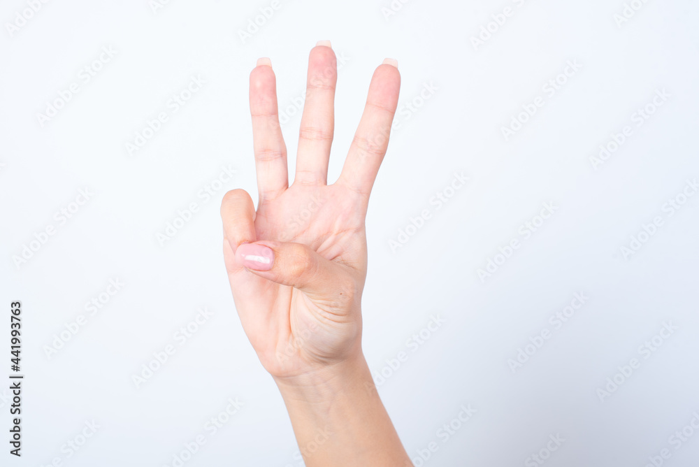 Woman's hand with pink manicure over isolated white background pointing up with fingers number three. Woman's hand with pink manicure over isolated white background pointing up with fingers number three.