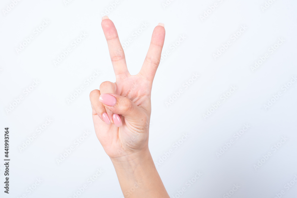Woman's hand with pink manicure over isolated white background pointing up with fingers number two. Woman's hand with pink manicure over isolated white background pointing up with fingers number two.