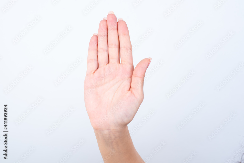 Woman's hand with pink manicure over isolated white background showing open palm making stop gesture. Woman's hand with pink manicure over isolated white background showing open palm making stop gesture.