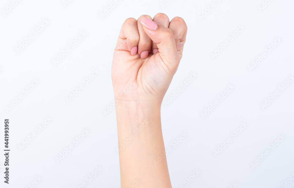 Woman's hand with pink manicure over isolated white background rising fist up. Woman's hand with pink manicure over isolated white background rising fist up.