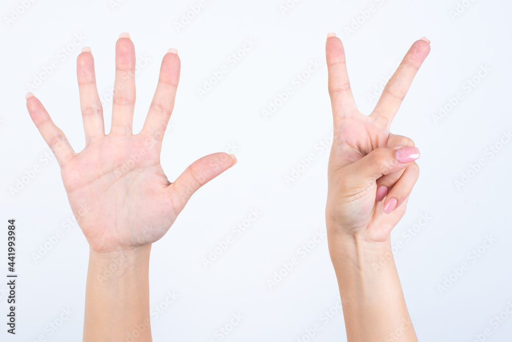 Woman's hands with pink manicure over isolated white background pointing with fingers number seven. Woman's hands with pink manicure over isolated white background pointing with fingers number seven.