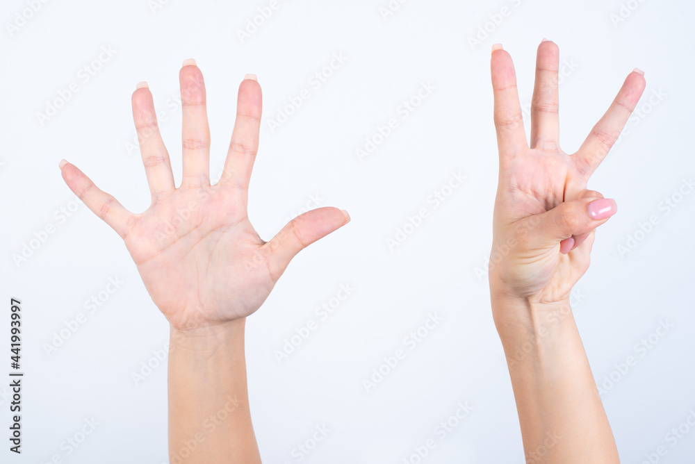 Woman's hands with pink manicure over isolated white background pointing with fingers number eight. Woman's hands with pink manicure over isolated white background pointing with fingers number eight.