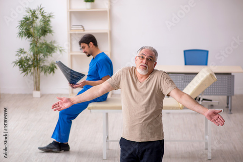 Old male patient visting young male doctor radilogist photo