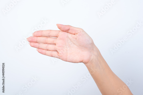 hand holding something on the palm, hand isolated over white background greeting someone saying hello. 