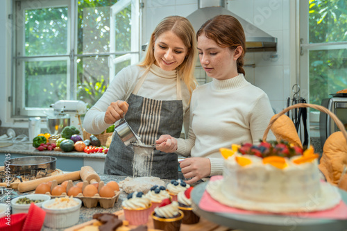 Mother and daughter are happily working together in baking.