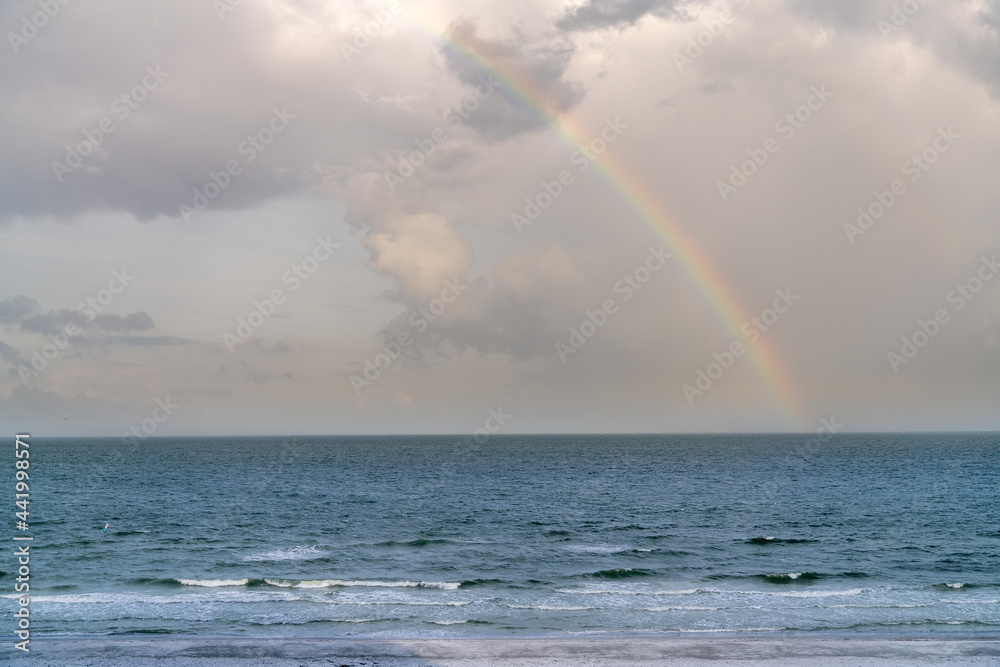 View of Rainbow in the Sky Over Calm Sean Waters